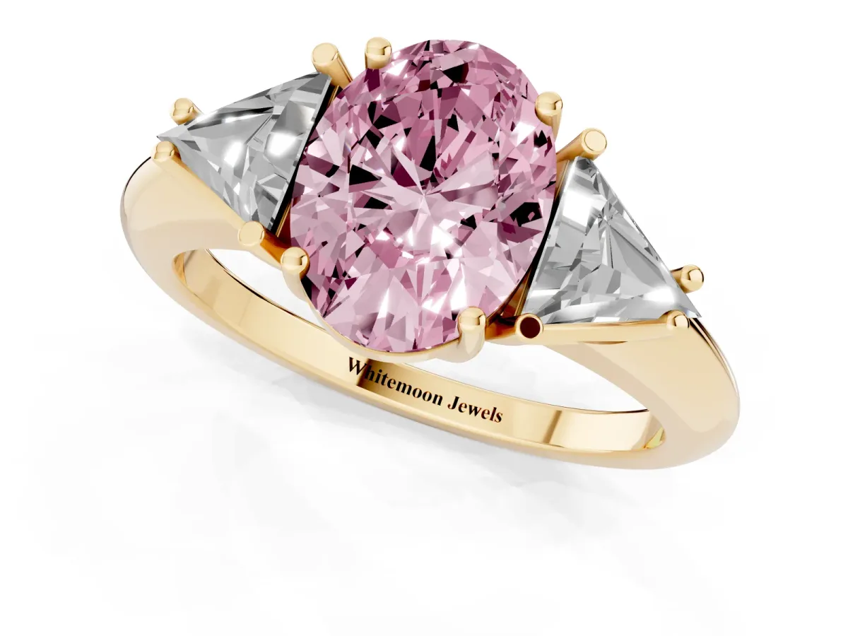 Fancy Pink Three-Stone Oval Cut Diamond Engagement Ring with Trillion Side Stones and Prong Setting Yellow gold