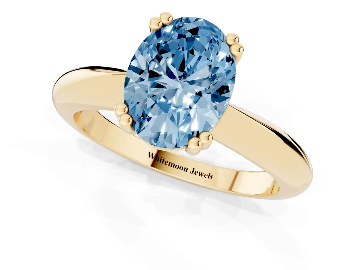 Fancy Blue Oval Cut Cut Solitaire Engagement Ring with Tapered Band and Four-Prong Setting Yellow gold