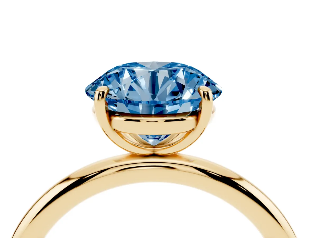 Fancy Blue Round Cut Solitaire Diamond Ring with Four-Prong Setting on a Plain Band Yellow gold