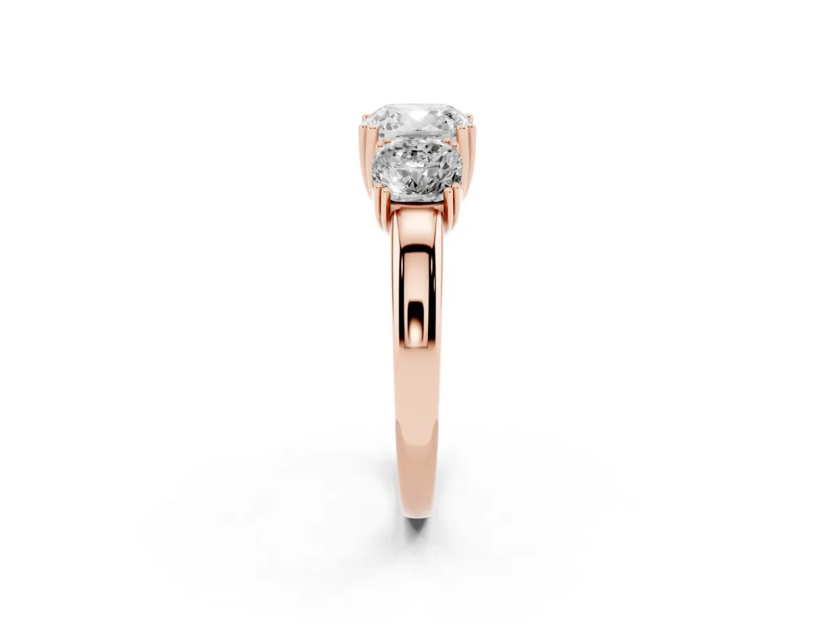 Three-Stone Cushion Cut Cut Diamond Ring with Channel Set Band and Four-Prong Setting Rose gold