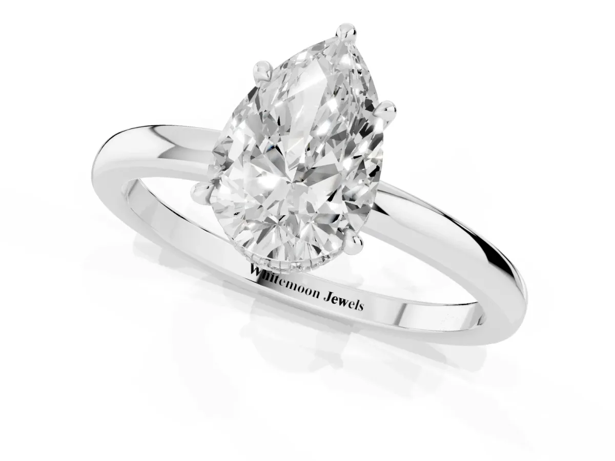 Pear Cut Solitaire Engagement Ring with Cathedral Band and Four-Prong Setting Silver
