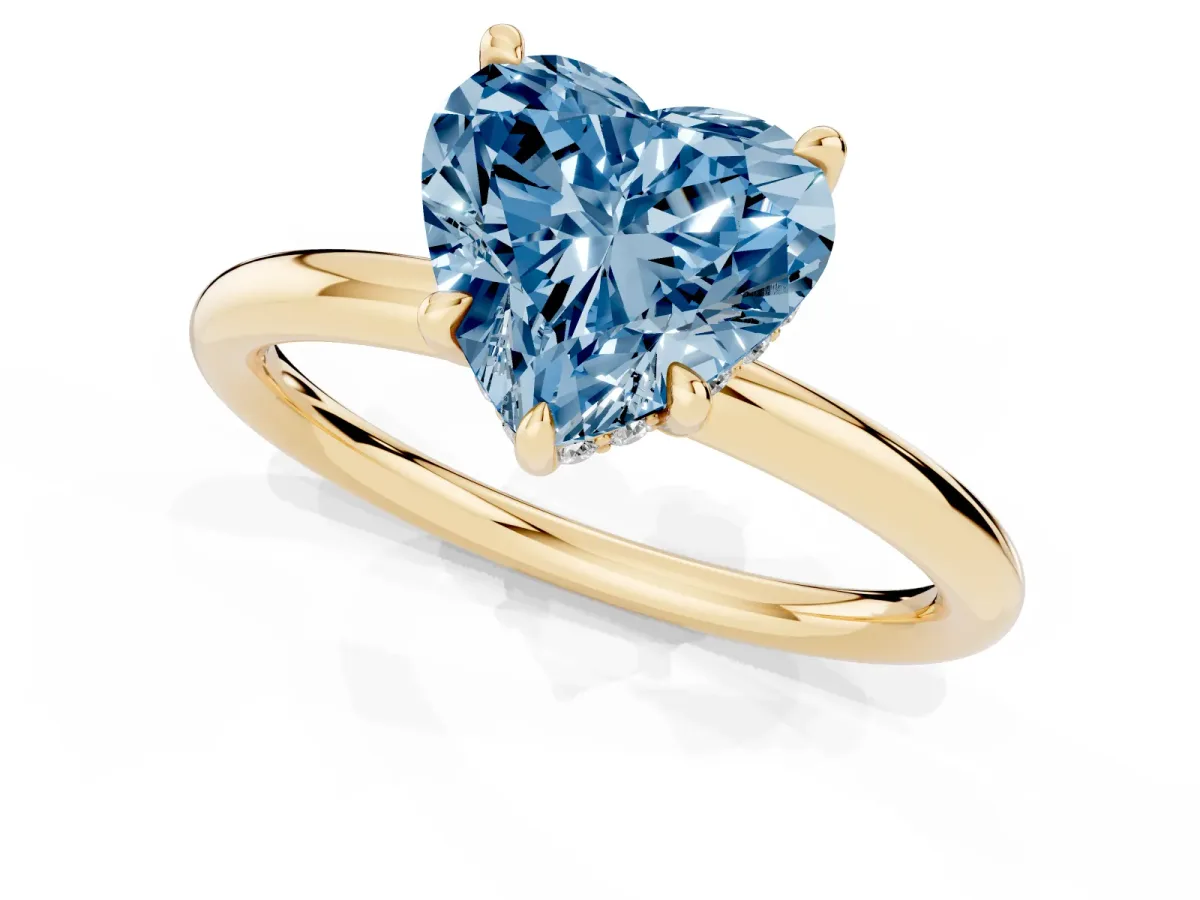Fancy Blue Heart Cut Diamond Solitaire Ring with Thin Band and Four-Prong Setting Yellow gold