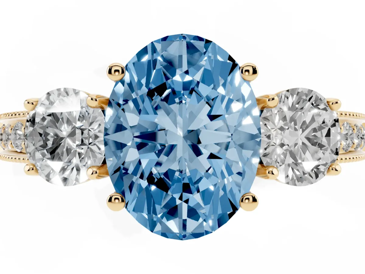Fancy Blue Oval Cut Three-Stone Diamond Ring with Pavé Band and Four-Prong Setting Yellow gold