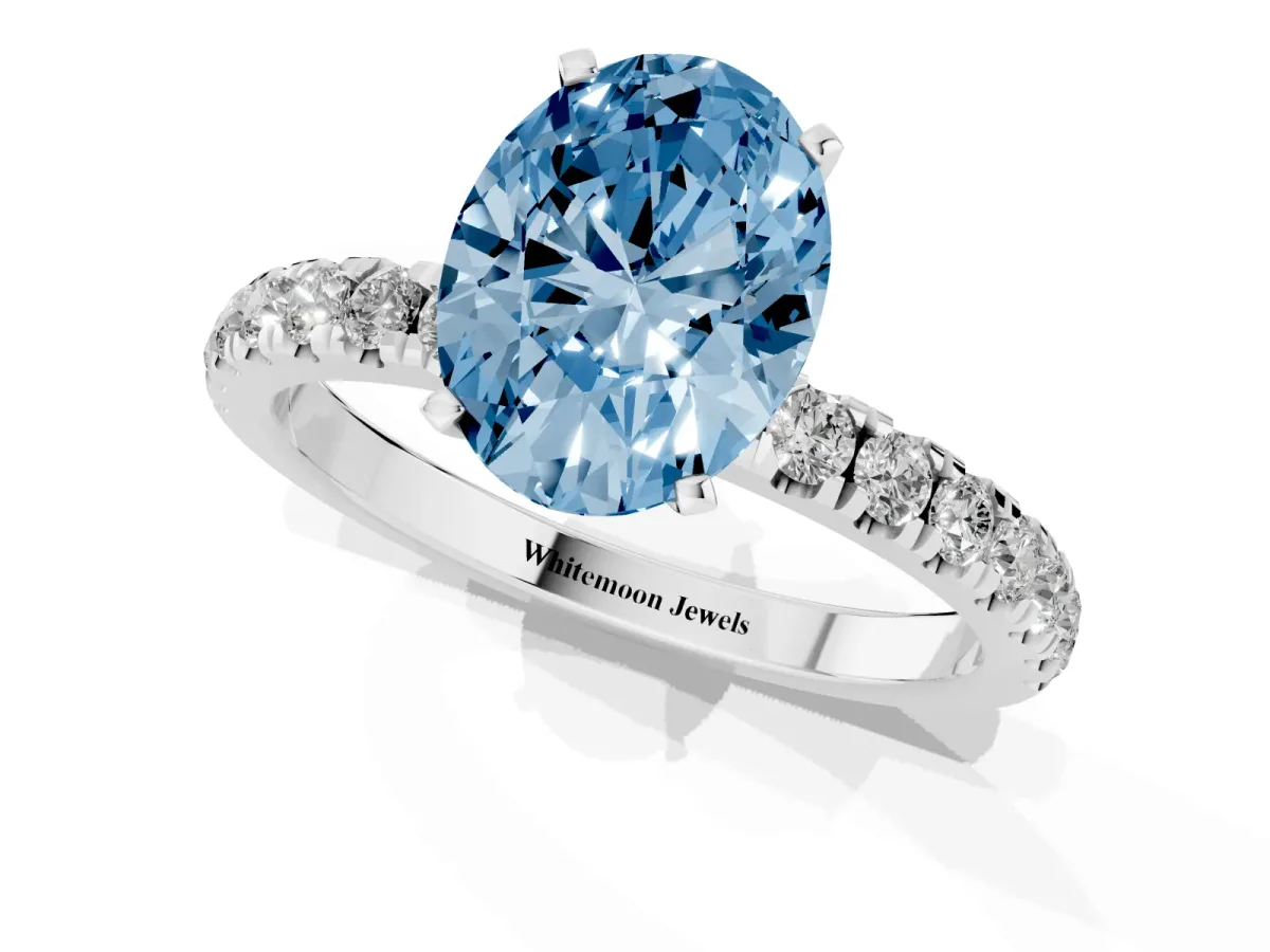 Fancy Blue Oval Cut Diamond Solitaire Ring with Pavé Accents and Four-Prong Setting Silver
