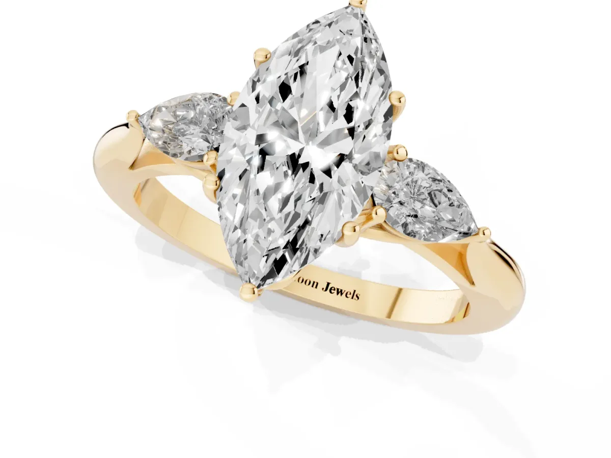 Marquise Cut Diamond Three-Stone Ring with Pear Side Stones and Prong Setting Yellow gold