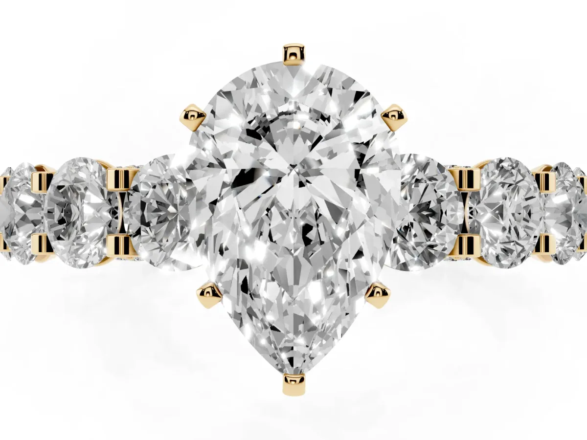 Pear Cut Diamond Side Stone Engagement Ring with Four-Prong Setting Yellow gold