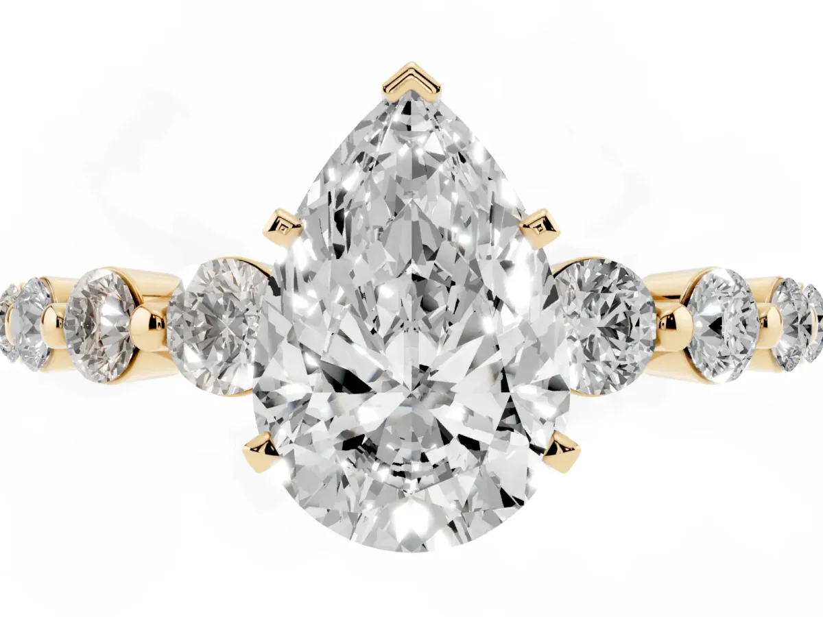 Pear Cut Solitaire Diamond Ring with Pave Band and Four-Prong Setting Yellow gold