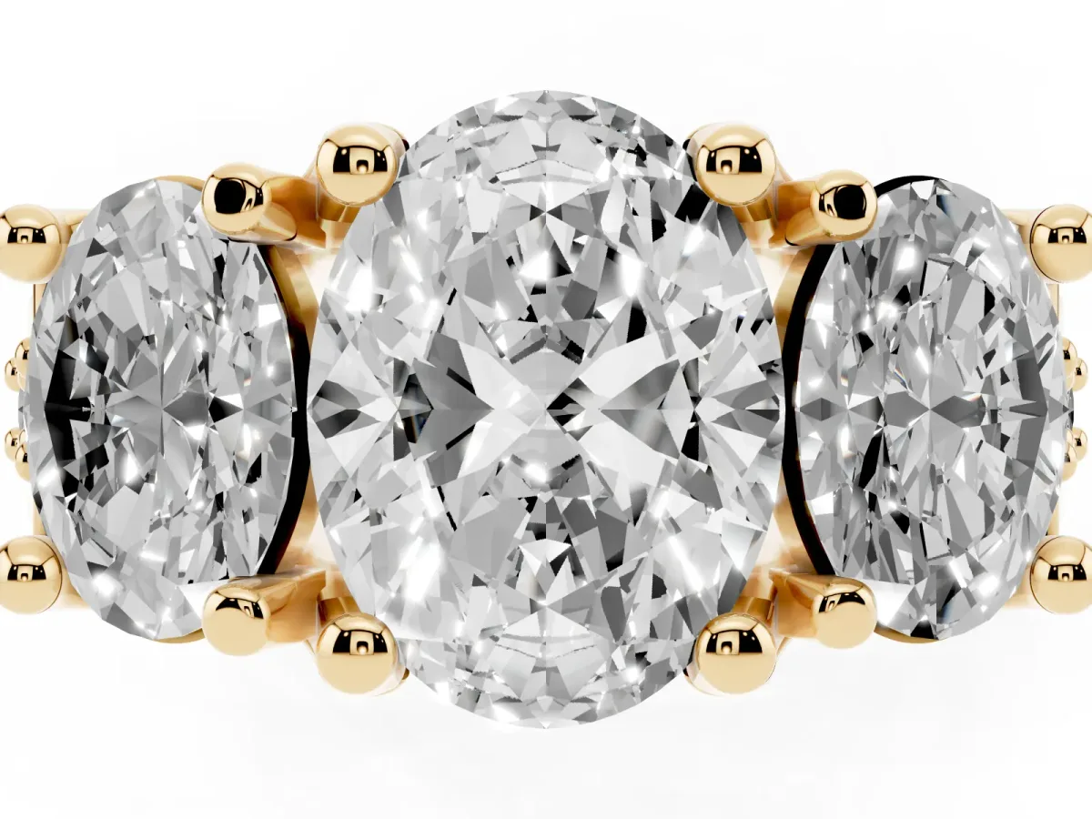 Oval Cut Diamond Three-Stone Ring with Channel Set Band and Four-Prong Setting Yellow gold
