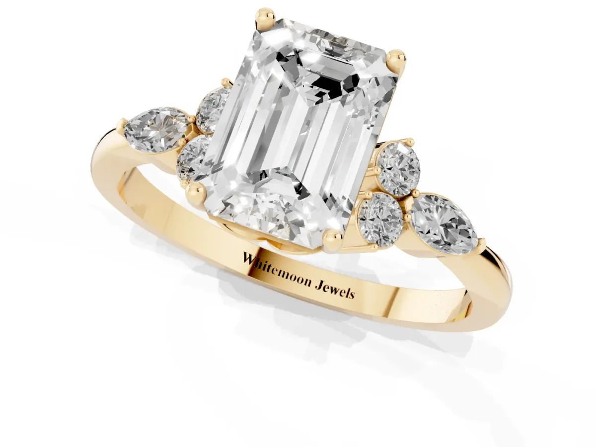 Emerald Cut Brilliant Diamond Solitaire Ring with Pear Side Stones and Four-Prong Setting Yellow gold