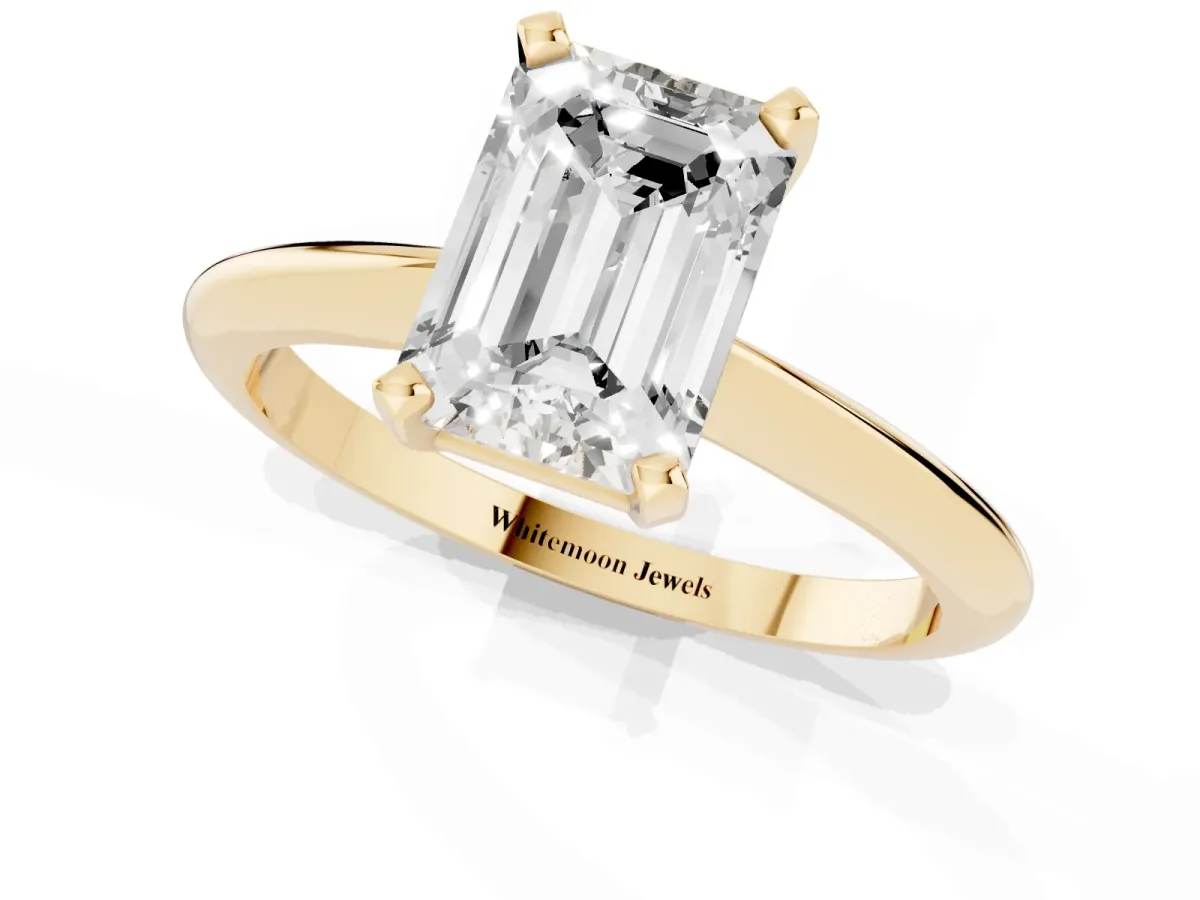 Emerald Cut Cut Solitaire Ring with Four-Prong Setting on a Classic Band Yellow gold