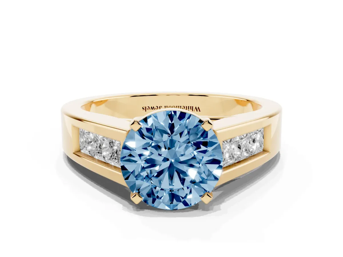 Fancy Blue Round Cut Cut Channel Set Solitaire Ring with Four-Prong Setting Yellow gold