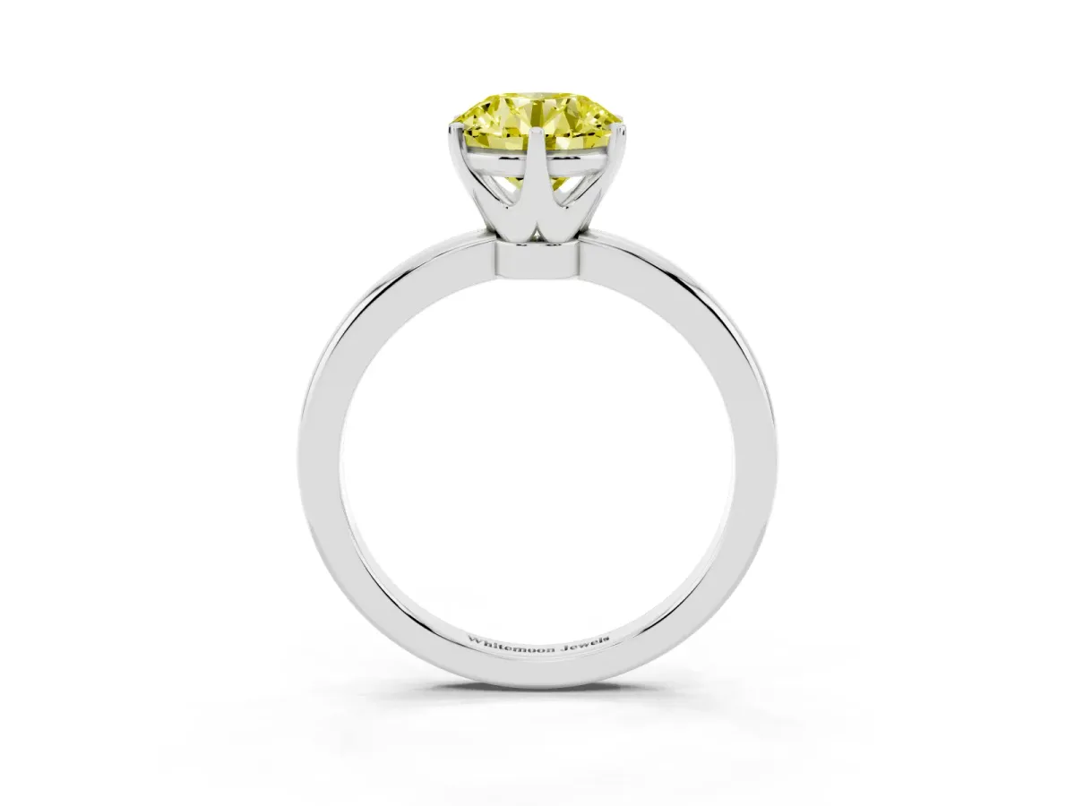 Fancy Yellow Round Cut Solitaire Diamond Ring with Six-Prong Setting on a Classic Band Silver