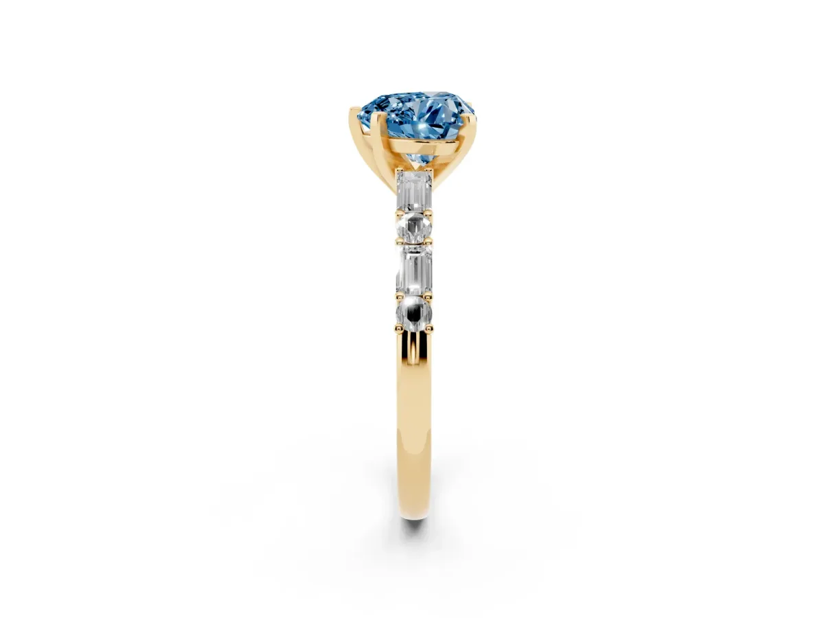 Fancy Blue Heart Cut Diamond Solitaire with Side Baguettes and Channel Set Band Yellow gold