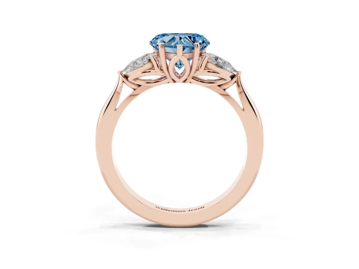Fancy Blue Three-Stone Heart Cut Brilliant Diamond Solitaire Ring with Tapered Band and Four-Prong Setting Rose gold