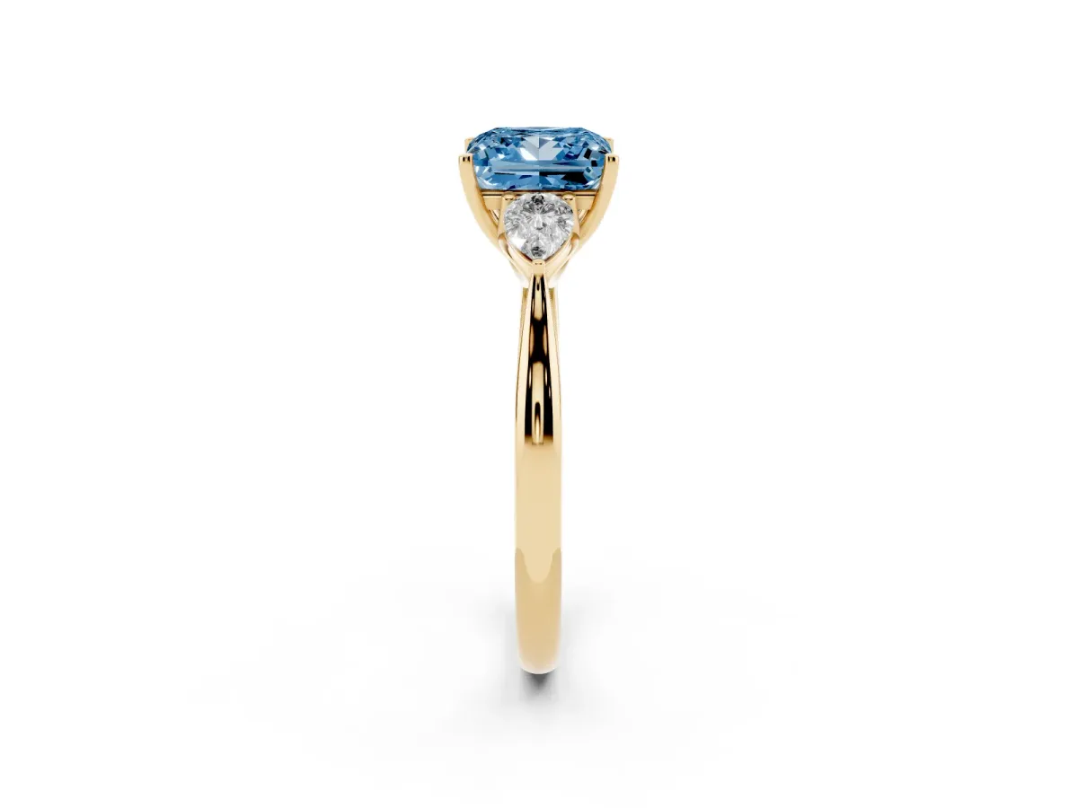 Fancy Blue Three-Stone Princess Cut Brilliant Diamond Solitaire Ring with Tapered Band and Four-Prong Setting Yellow gold