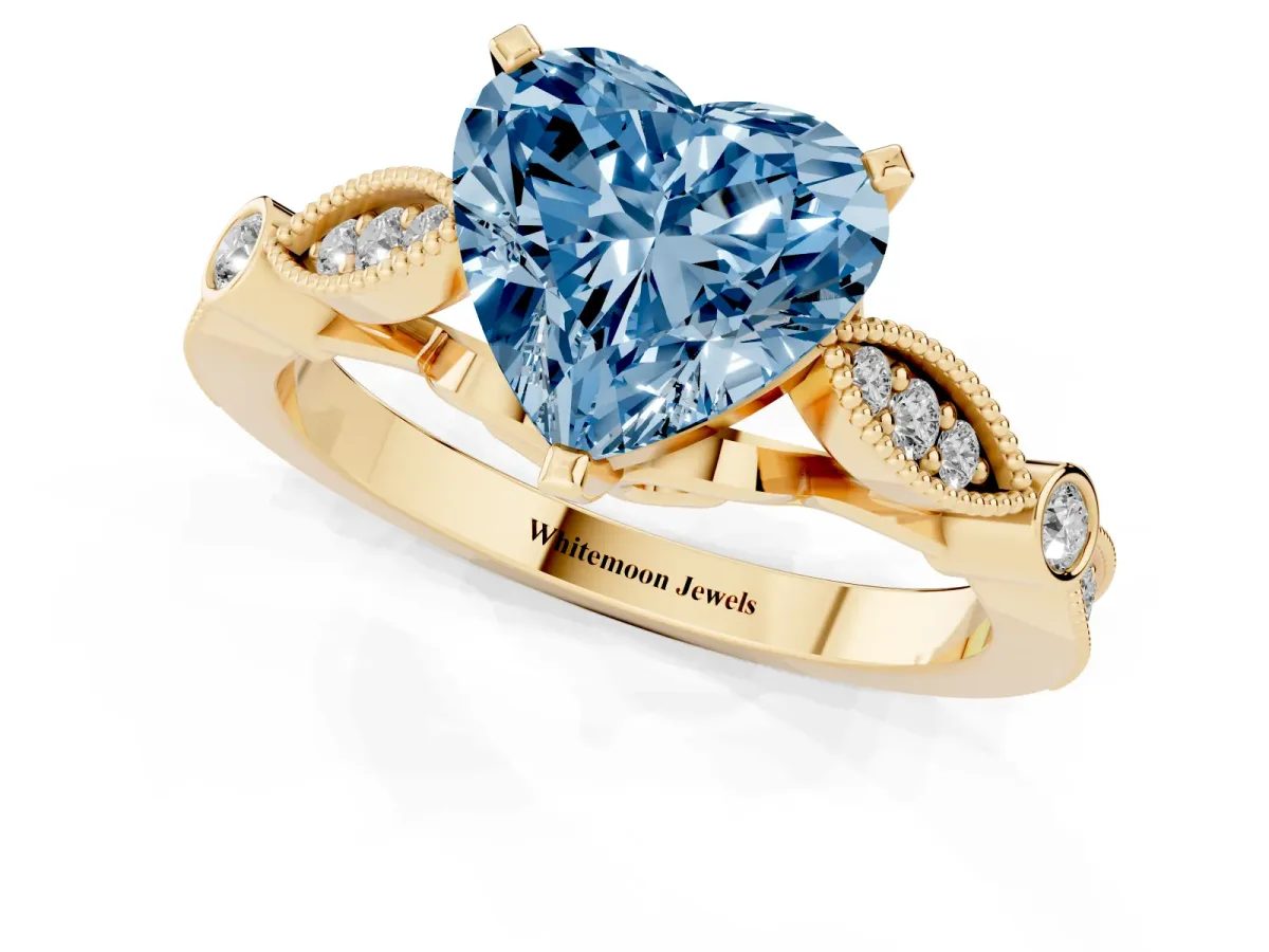 Fancy Blue Heart Cut Cut Diamond with Milgrain Marquise and Bezel Accents on a Solitaire Band with Prong Setting Yellow gold