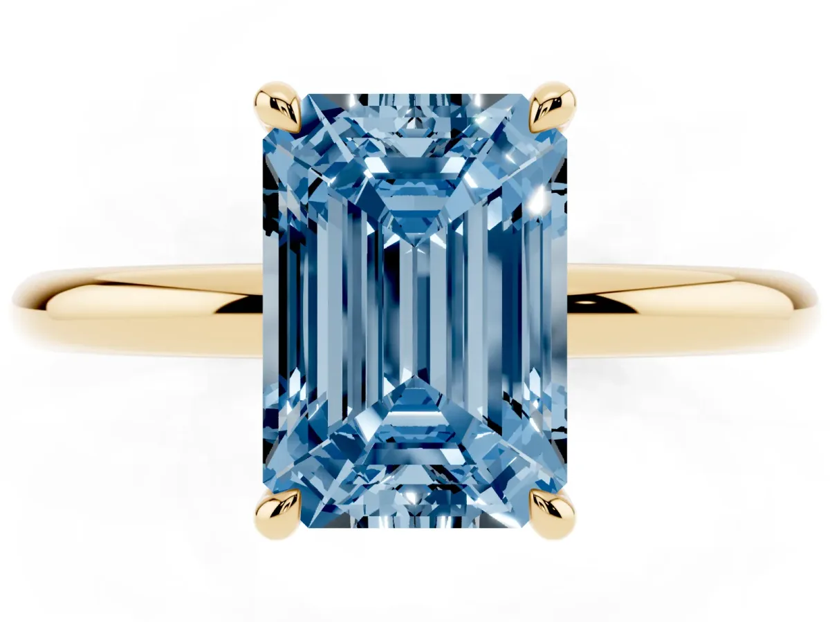Fancy Blue Emerald Cut Diamond Solitaire Ring with Thin Band and Four-Prong Setting Yellow gold