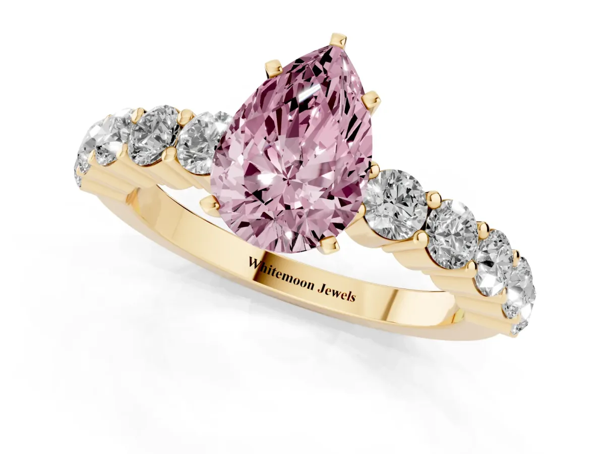 Fancy Pink Pear Cut Diamond Solitaire Ring with Shared Prong Round Side Stones Yellow gold