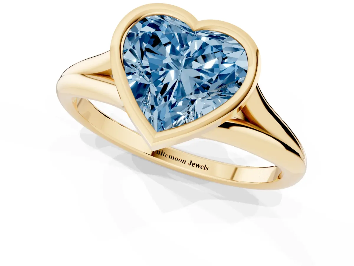 Fancy Blue Bezel Set Heart Cut Cut Solitaire Ring with Tapered Band Yellow gold