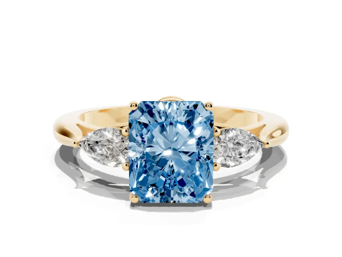 Fancy Blue Radiant Cut Diamond Three-Stone Ring with Pear Side Stones and Prong Setting Yellow gold
