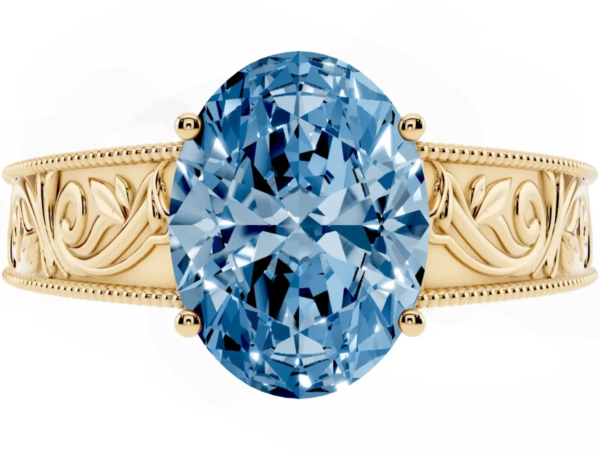 Fancy Blue Oval Cut Diamond Solitaire Ring with Engraved Band and Four-Prong Setting Yellow gold
