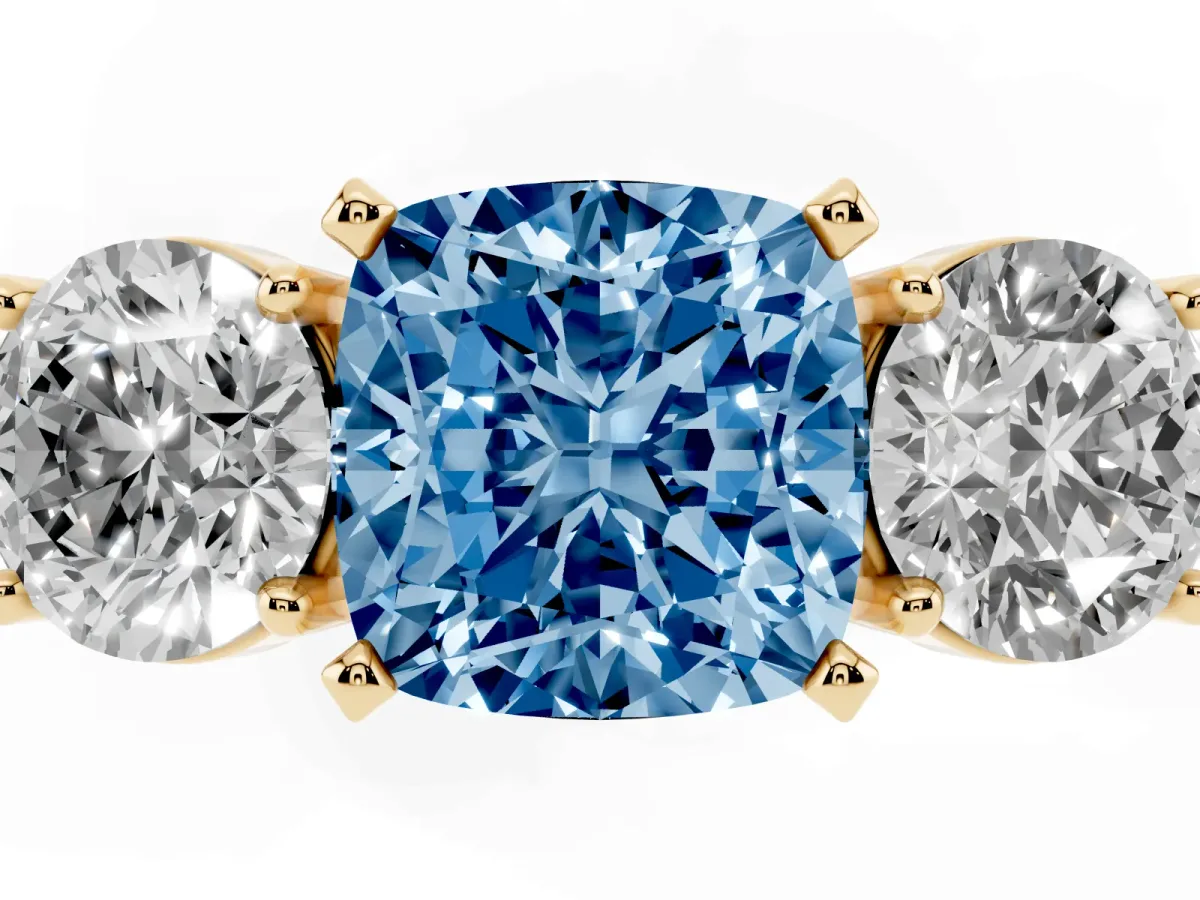 Fancy Blue Three-Stone Cushion Cut Diamond Ring with Round Side Stones, Classic Band, and Four-Prong Setting Yellow gold