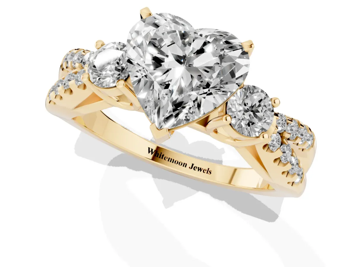 Heart Cut Diamond Three-Stone Ring with Pavé Split Shank and Four-Prong Setting Yellow gold