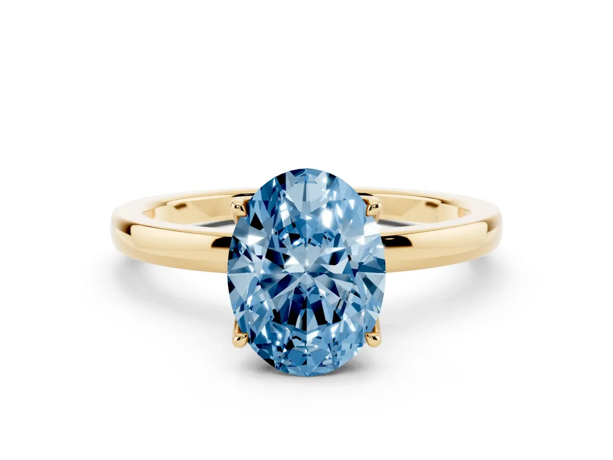 Fancy Blue Oval Cut Diamond Solitaire Ring with Thin Band and Prong Setting Yellow gold