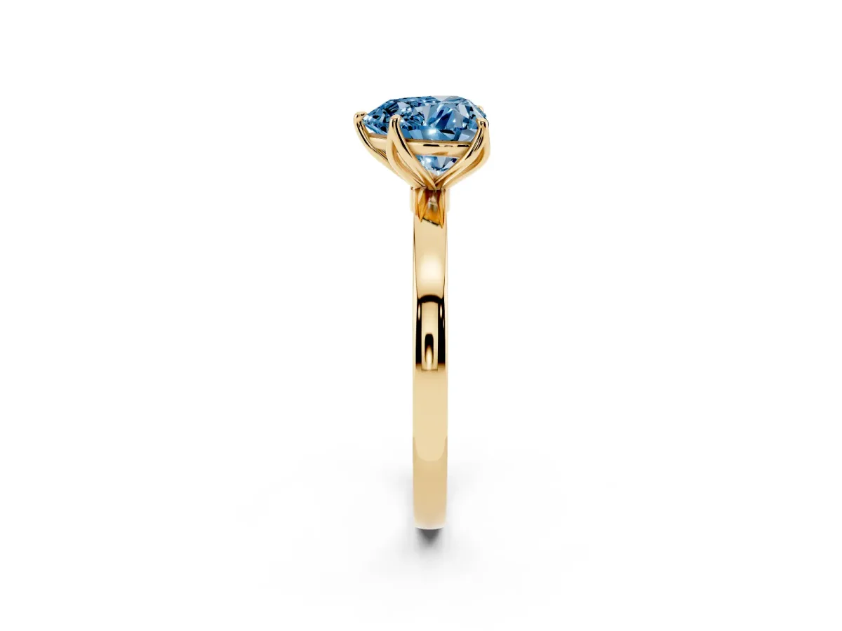 Fancy Blue Heart Cut Diamond Solitaire Ring with Thin Band and Prong Setting Yellow gold