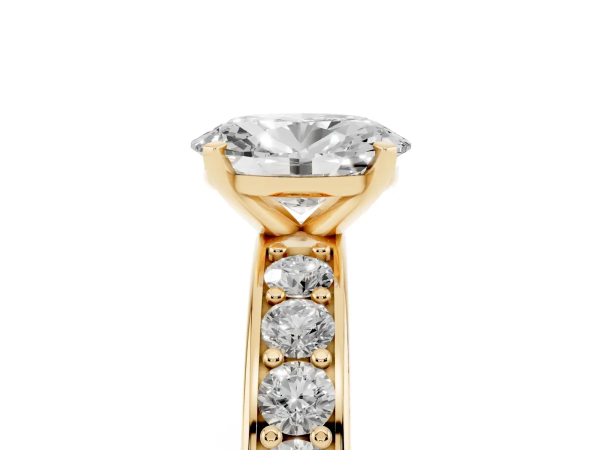 Oval Cut Diamond Engagement Ring with Channel Set Round Band and Prong Setting Yellow gold