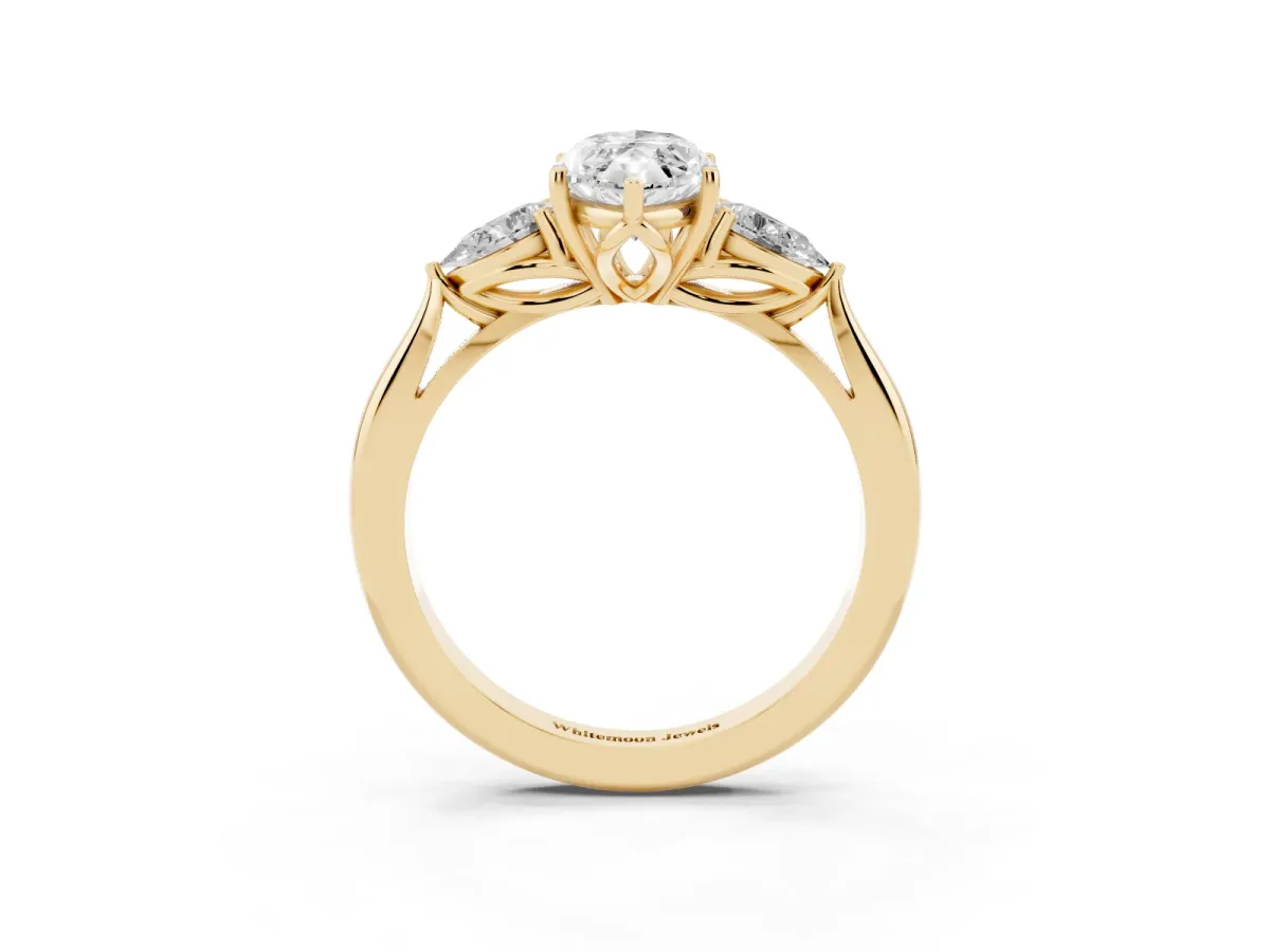 Three-Stone Marquise Cut Diamond Ring with Pear Side Stones in Four-Prong Setting Yellow gold