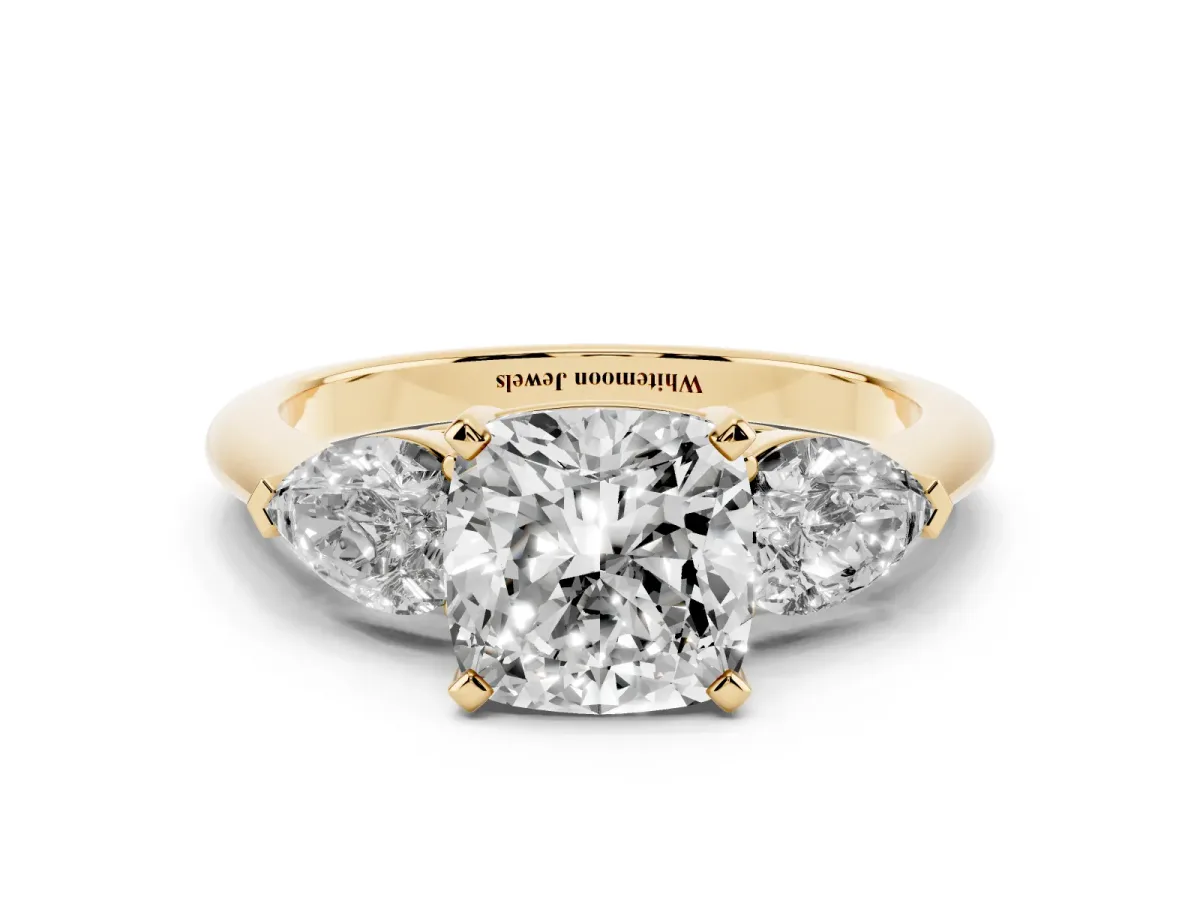 Three-Stone Cushion Cut Diamond Ring with Pear Side Stones and Four-Prong Setting Yellow gold