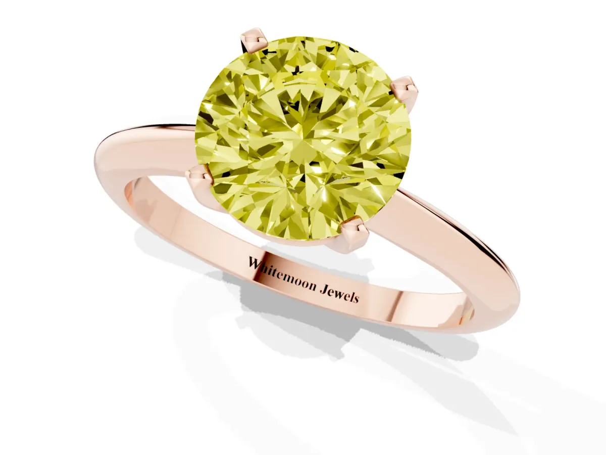 Fancy Yellow Round Cut Cut Solitaire Ring with Four-Prong Setting on a Classic Band Rose gold