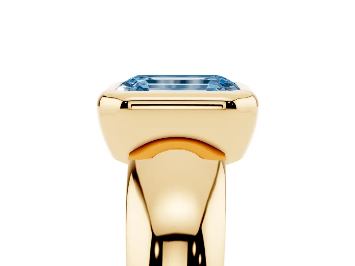Fancy Blue Bezel Set Emerald Cut Solitaire Ring with Wide Band Yellow gold