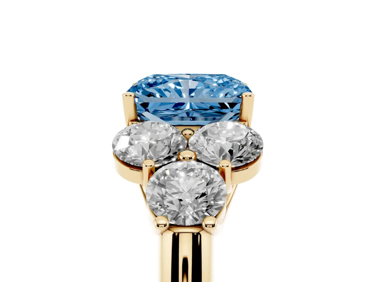 Fancy Blue Radiant Cut Cut Diamond Cluster Ring with Round Accent Stones and Prong Setting on a Classic Band Yellow gold