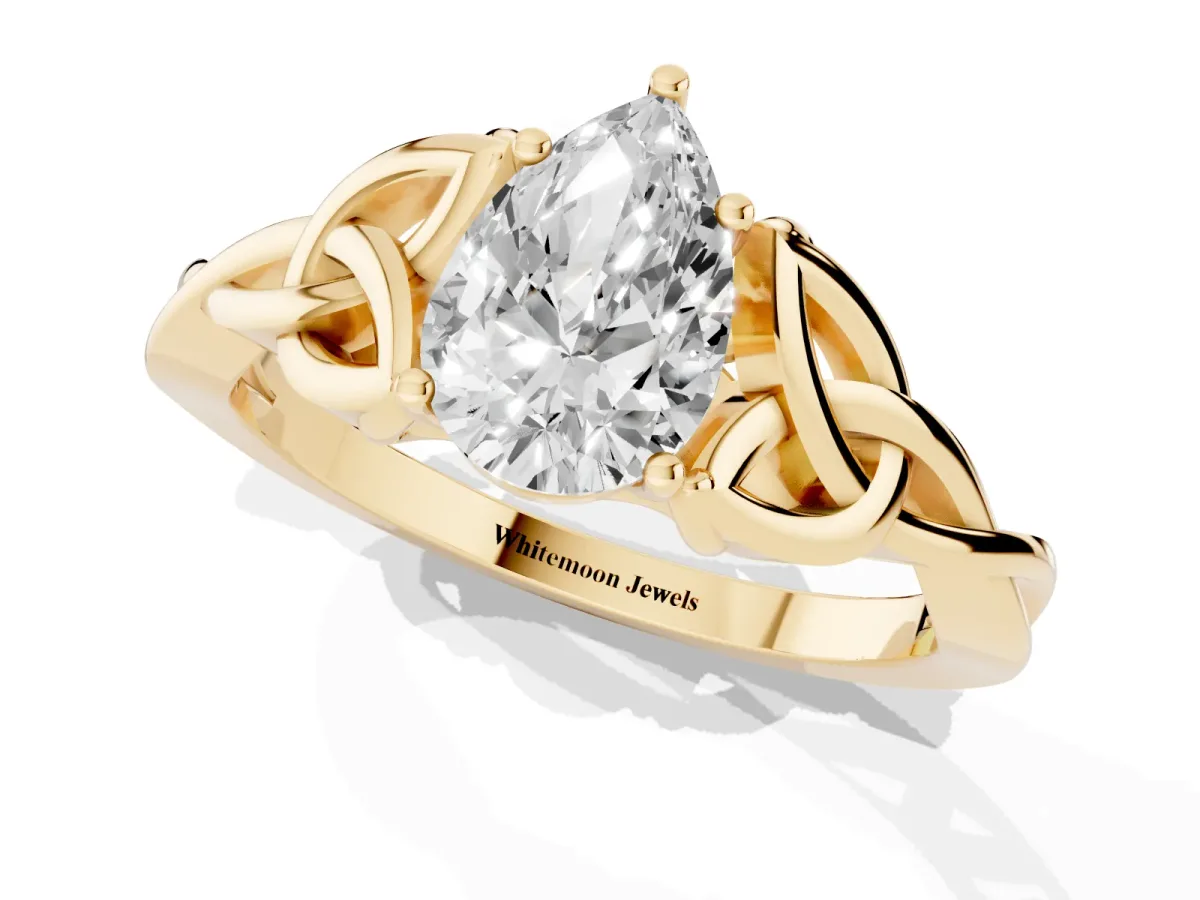 Pear Cut Diamond Solitaire Engagement Ring with Celtic Knot Band and Four-Prong Setting Yellow gold