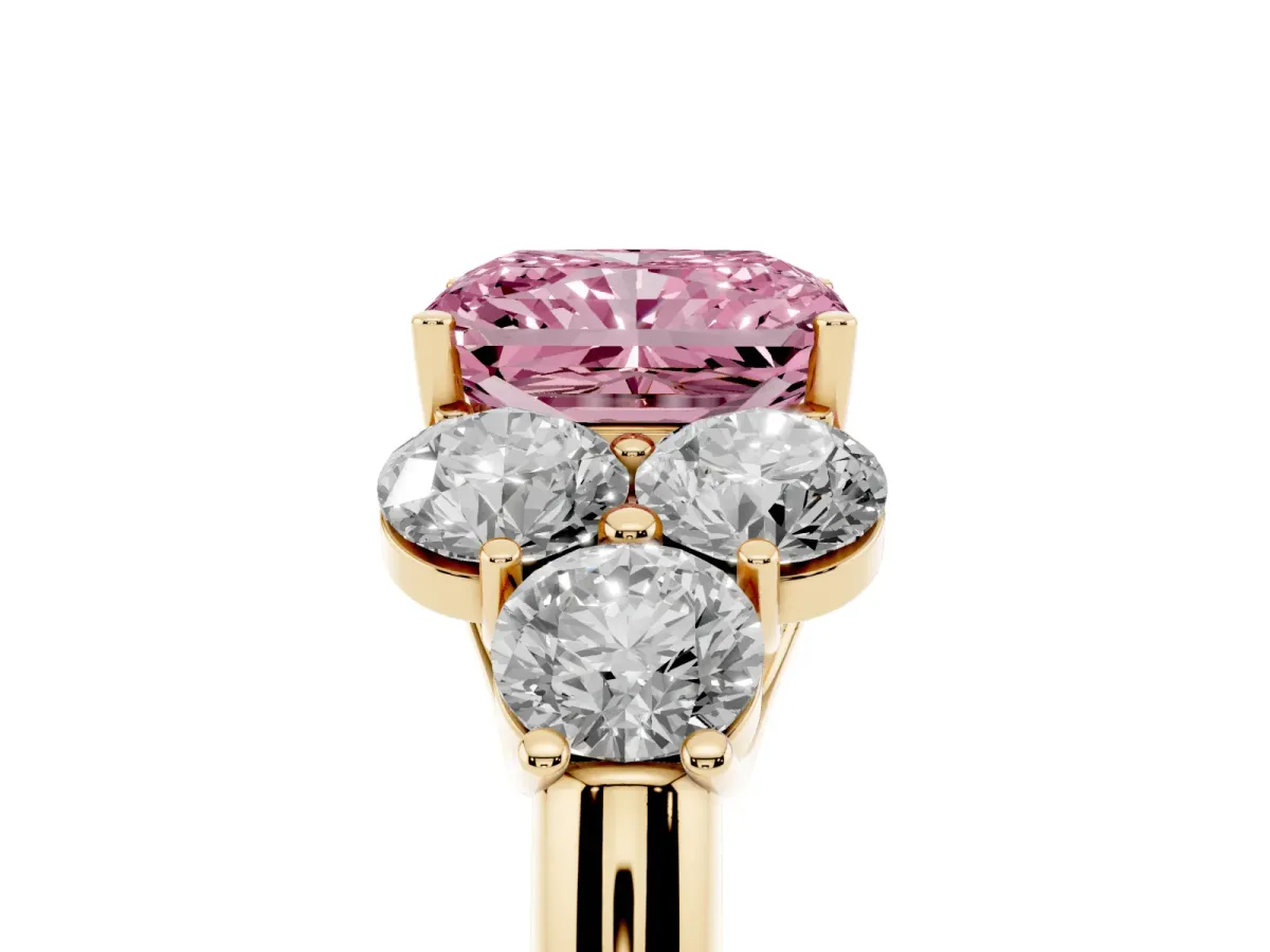 Fancy Pink Radiant Cut Cut Diamond Cluster Ring with Round Accent Stones and Prong Setting on a Classic Band Yellow gold