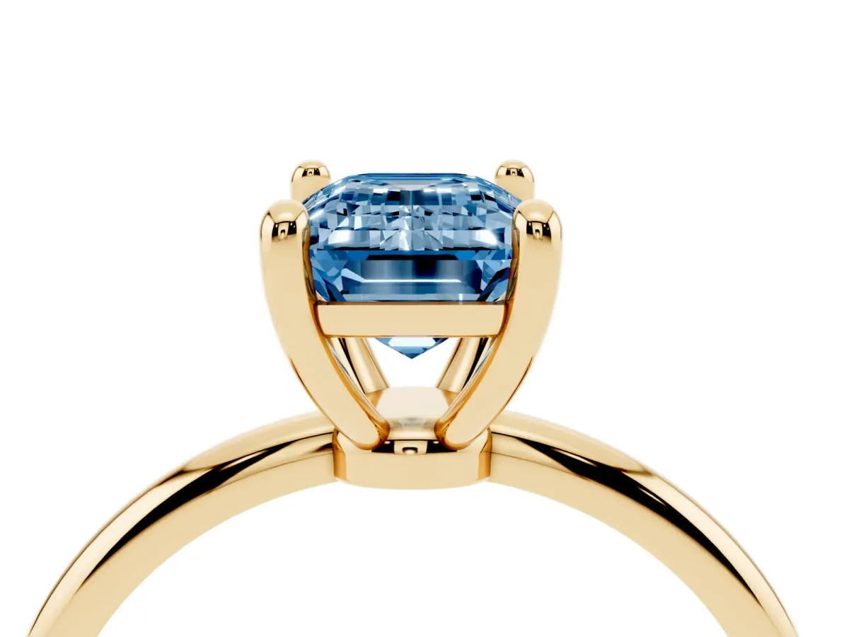 Fancy Blue Emerald Cut Solitaire Diamond Ring with 4-Prong Setting on a Classic Band Yellow gold