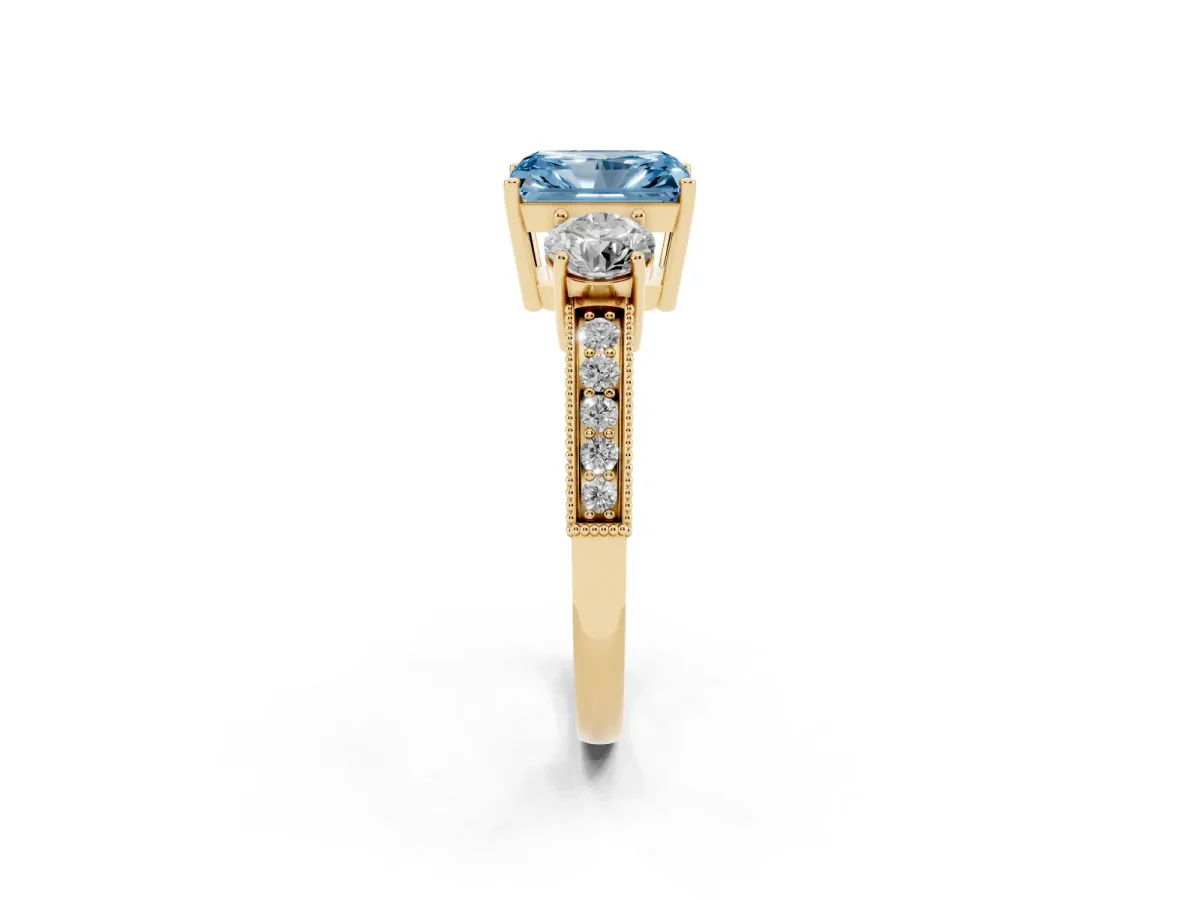 Fancy Blue Radiant Cut Three-Stone Diamond Ring with Pavé Band and Four-Prong Setting Yellow gold