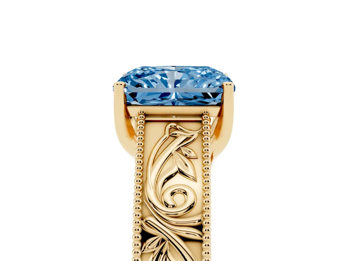 Fancy Blue Radiant Cut Diamond Solitaire Ring with Engraved Band and Four-Prong Setting Yellow gold