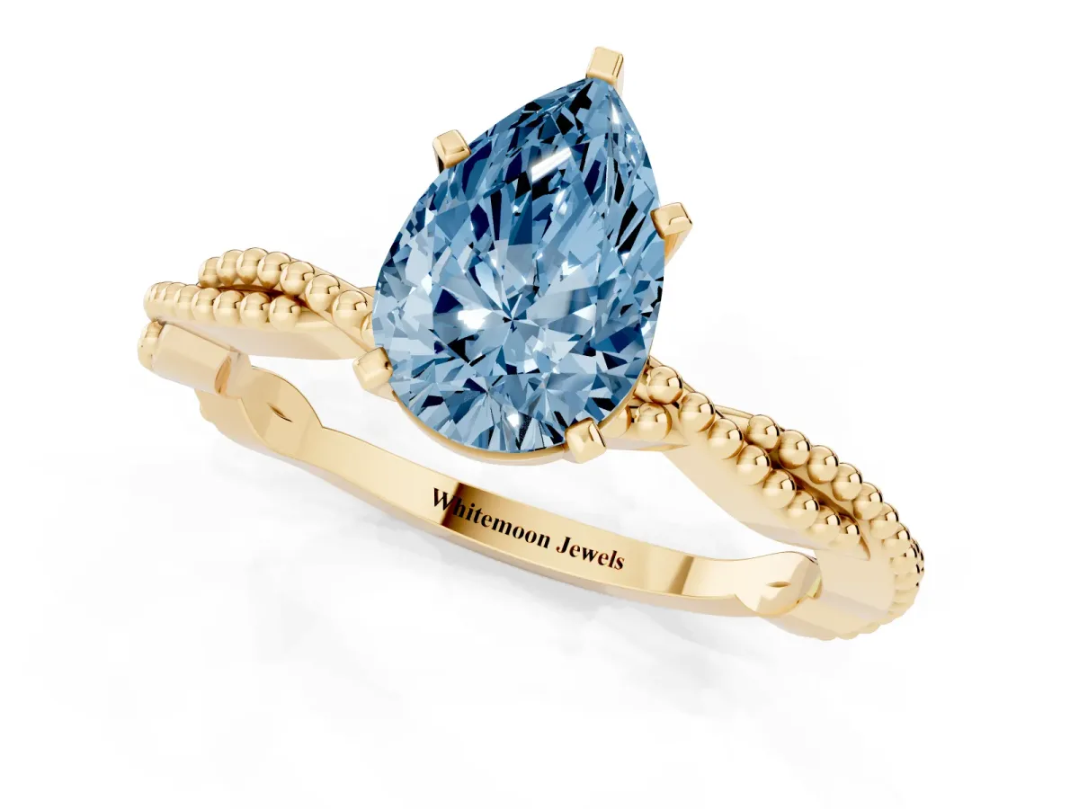 Fancy Blue Pear Cut Solitaire Twisted Band with Bead Prong Setting Yellow gold