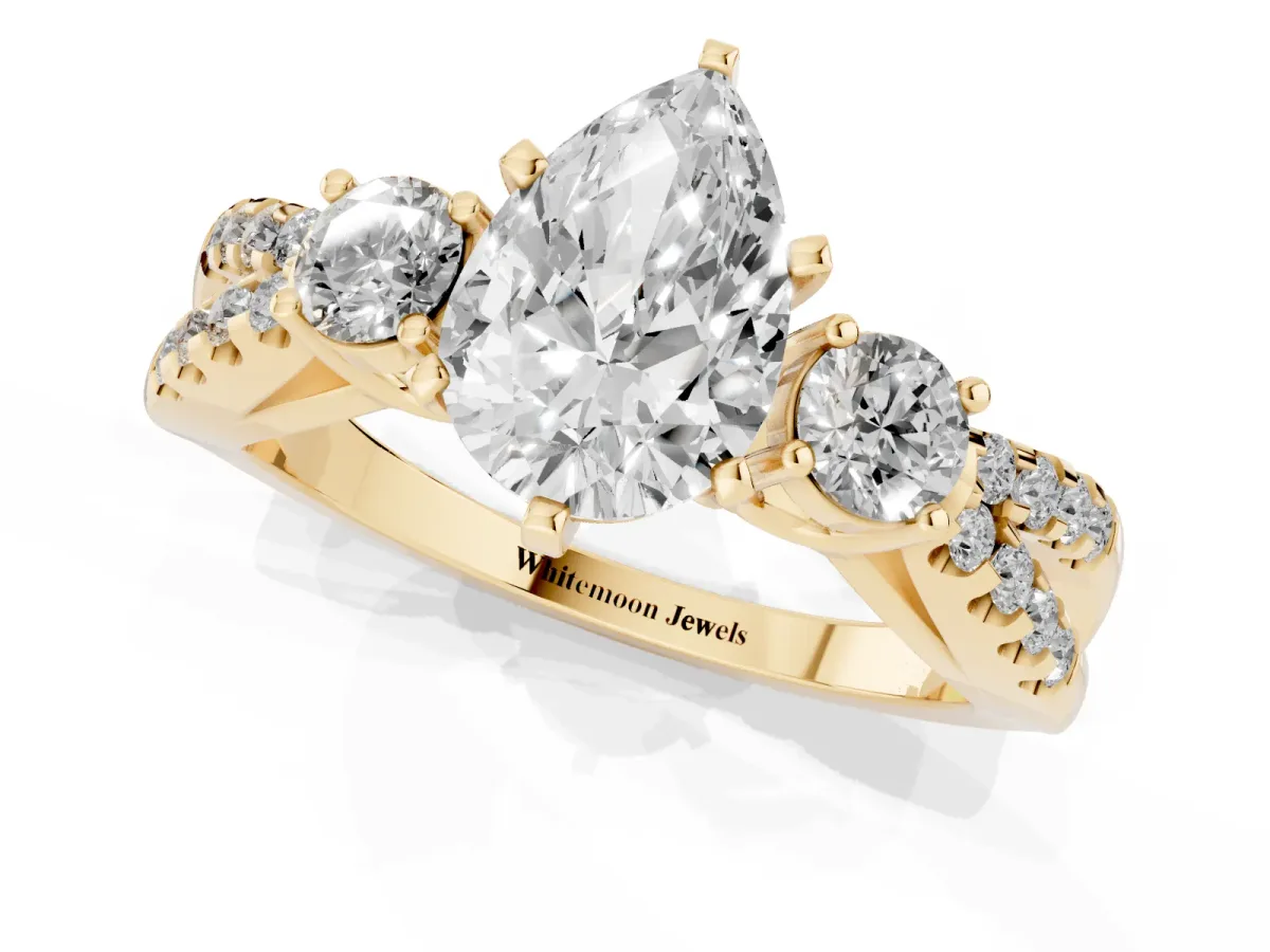 Pear Cut Diamond Three-Stone Ring with Pavé Split Shank and Four-Prong Setting Yellow gold