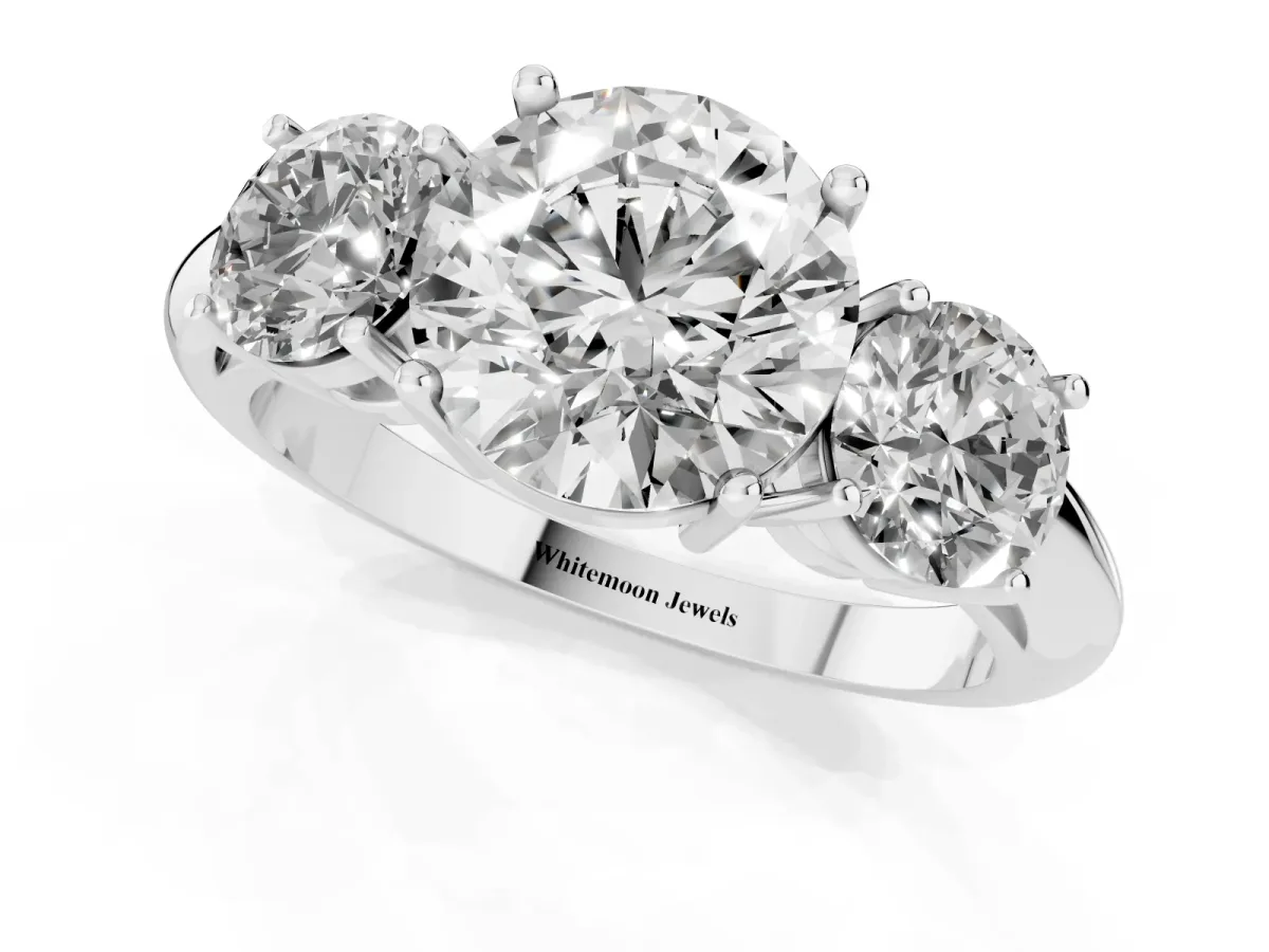 Three-Stone Round Cut Cut Diamond Engagement Ring with Prong Setting on a White Gold Band Platinum