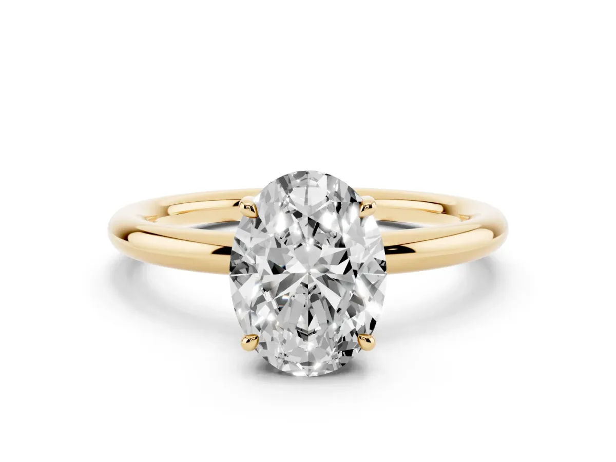 Oval Cut Diamond Solitaire Ring with Thin Band and Four-Prong Setting Yellow gold