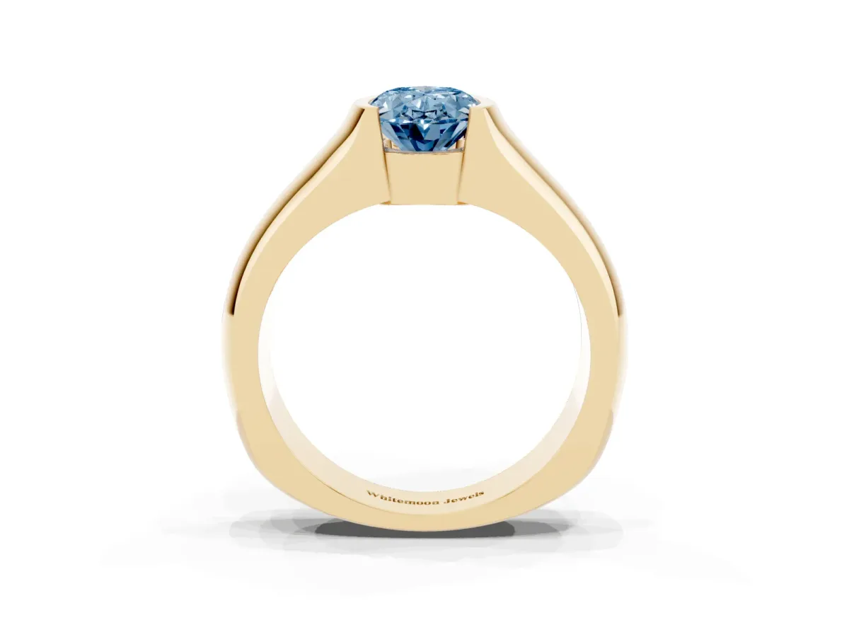 Fancy Blue Oval Cut Solitaire Bezel Set Diamond Ring with Wide Band Yellow gold