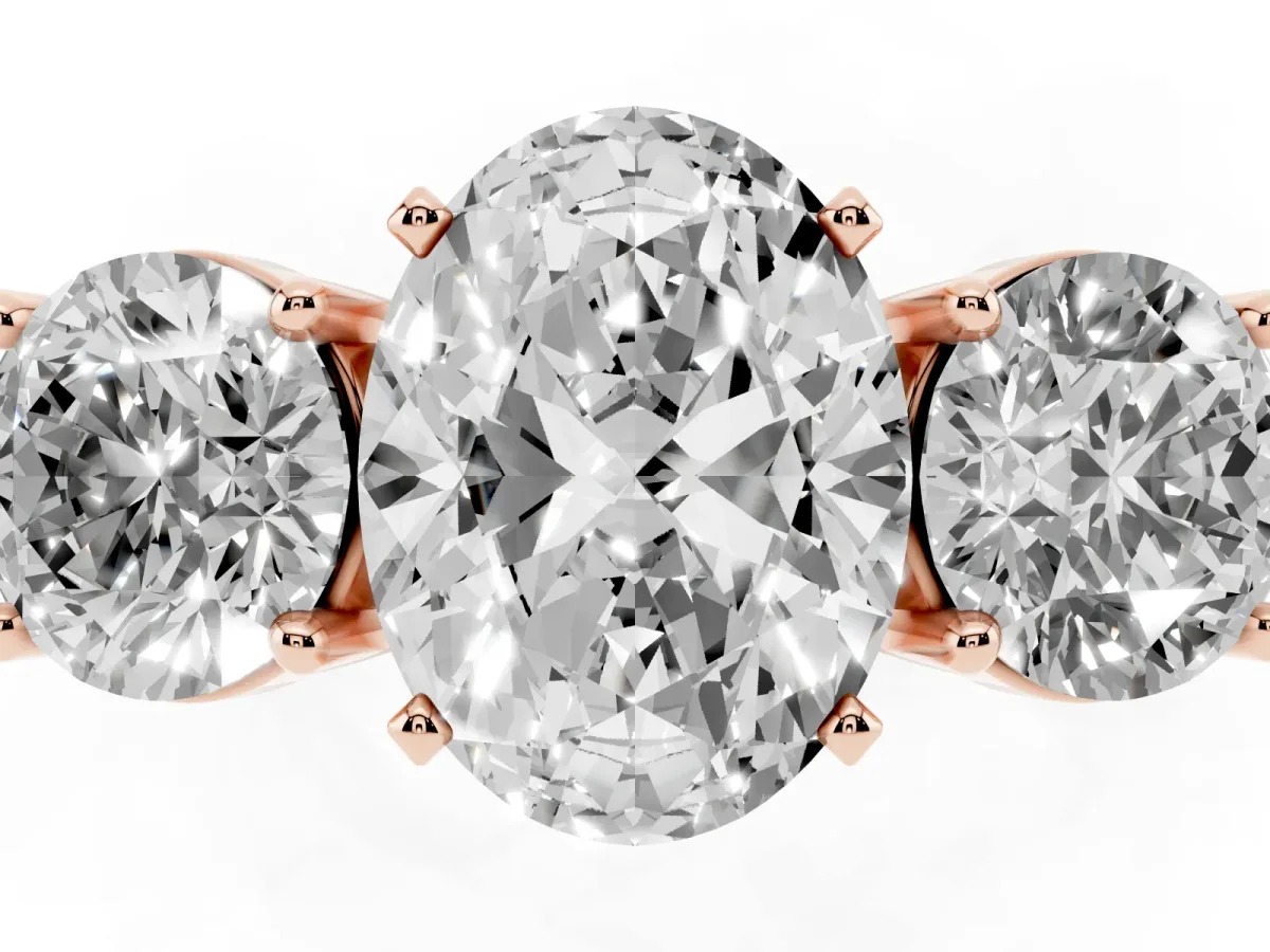 Three-Stone Oval Cut Diamond Ring with Round Side Stones, Classic Band, and Four-Prong Setting Rose gold