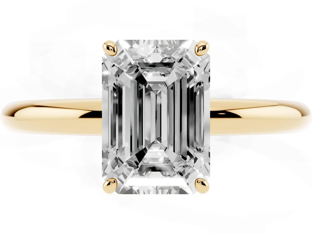 Emerald Cut Solitaire Diamond Ring with Four-Prong Setting on a Plain Band Yellow gold