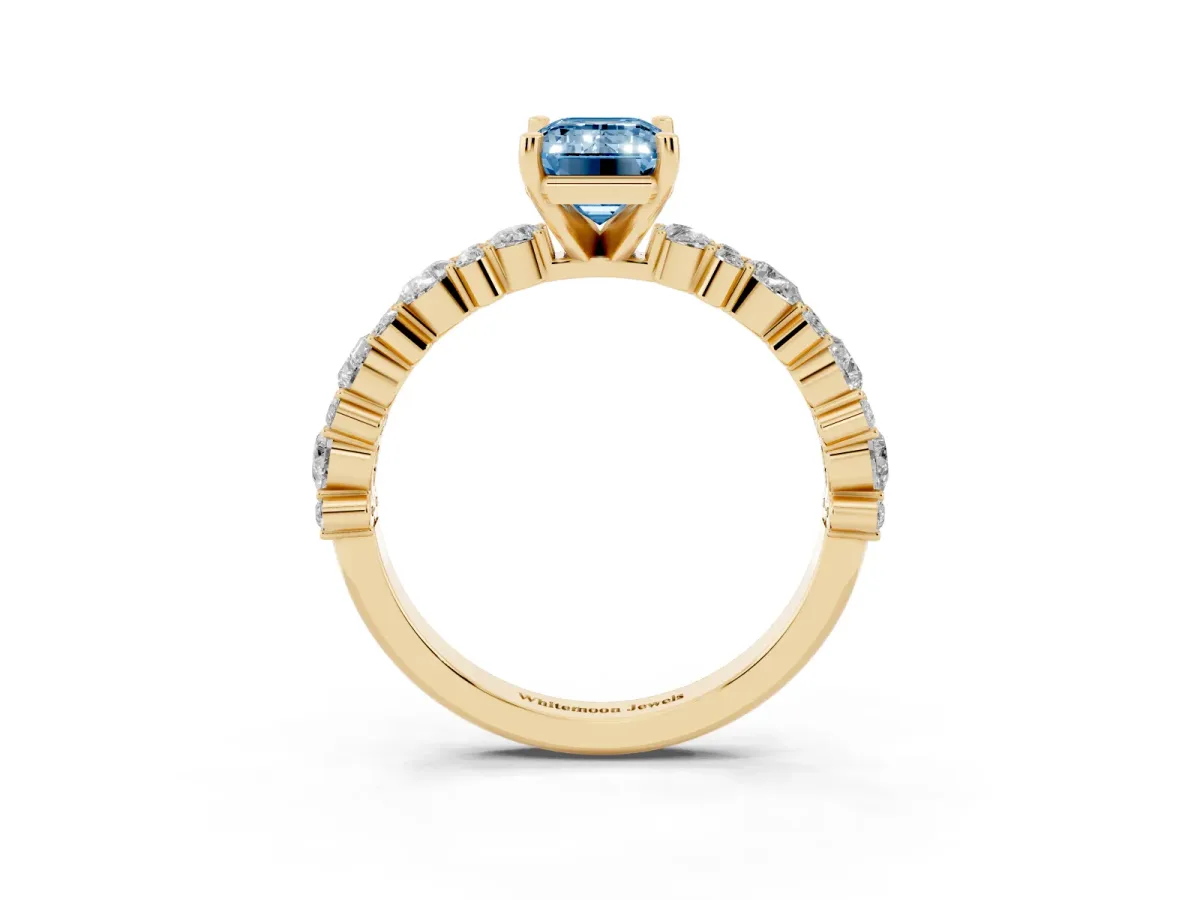 Fancy Blue Emerald Cut Diamond Side Stone Solitaire Ring with Round and Four-Prong Setting Yellow gold