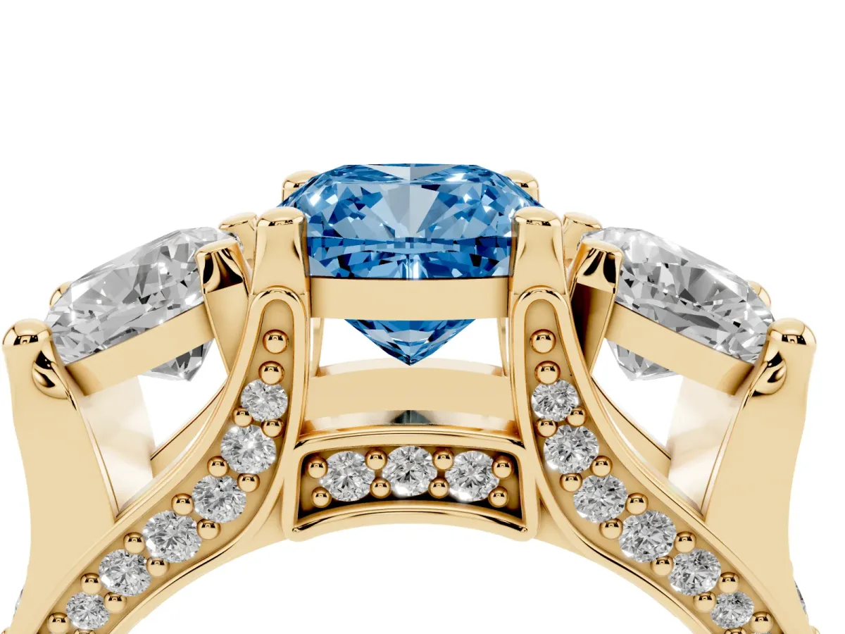 Fancy Blue Cushion Cut Diamond Three-Stone Ring with Channel Set Band and Four-Prong Setting Yellow gold