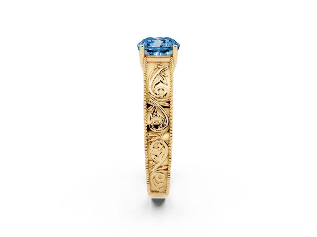 Fancy Blue Cushion Cut Diamond Solitaire Ring with Engraved Band and Four-Prong Setting Yellow gold